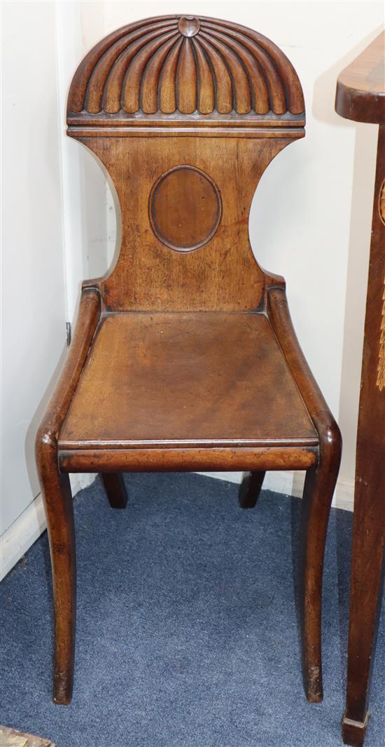 Two Regency carved mahogany hall chairs